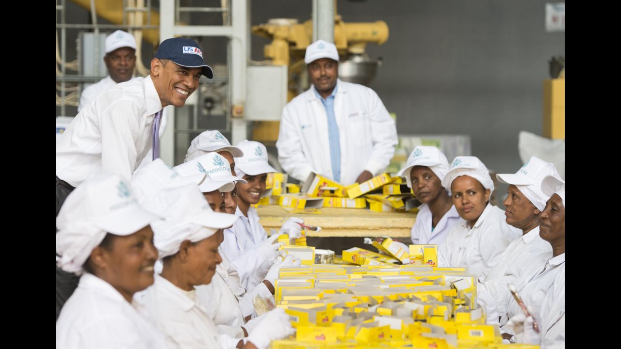 Obama stands alongside workers at Faffa Food as they pack boxes of food products in Addis Ababa on July 28. Faffa Food produces low-cost and high-protein foods.