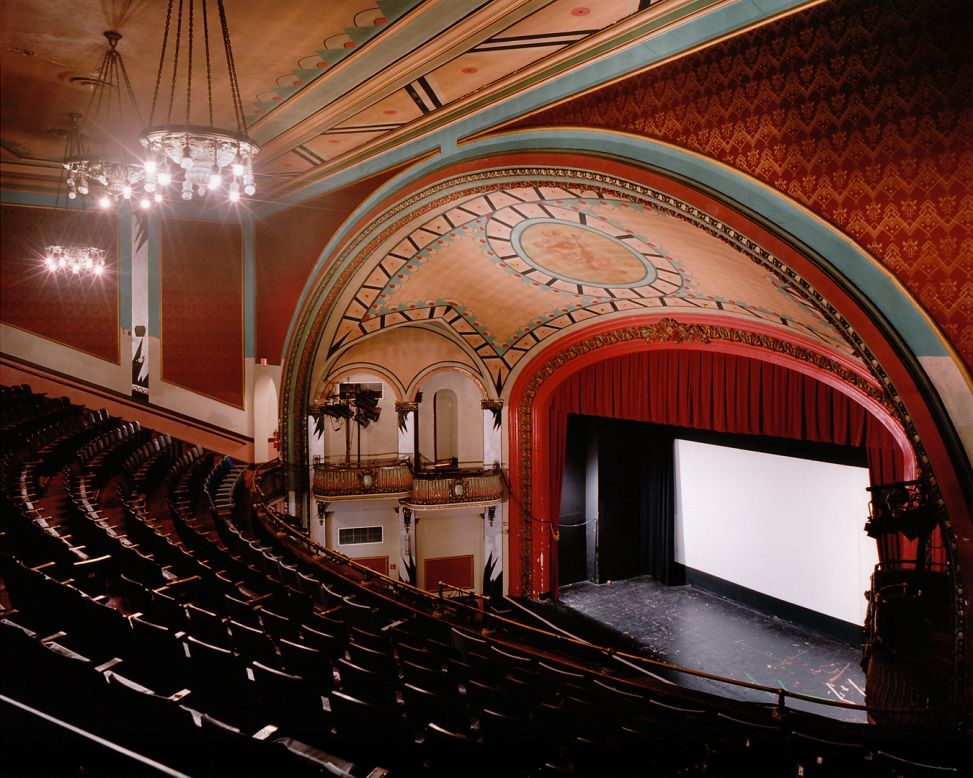 This theater, built in 1914, was designed primarily for stage performances, opera and films, which were relatively new at the time. <br />Now it shows the very latest film releases and special film series, including classics such as Boogie Nights and Jaws. <br />What are these old school cinemas like when the films are over? "It's very contemplative," says Klavens. <br />"I work with long exposures in the theaters interiors  -- I don't add any lights -- and sometimes it is quite dark, and details come out that are not even visible to me." 