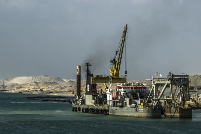 A dredger is seen at work on the new waterway of the Suez Canal on June 13, 2015, in the port city of Ismailia, east of Cairo. Dubbed the Suez Canal Axis, the new 72-kilometer project is aimed at speeding up traffic along the existing waterway and boosting revenues for Egypt. 41,000 people have been working since construction began last August, moving a total of half a trillion cubic meters of earth -- equivalent to moving 200 Great Pyramids.