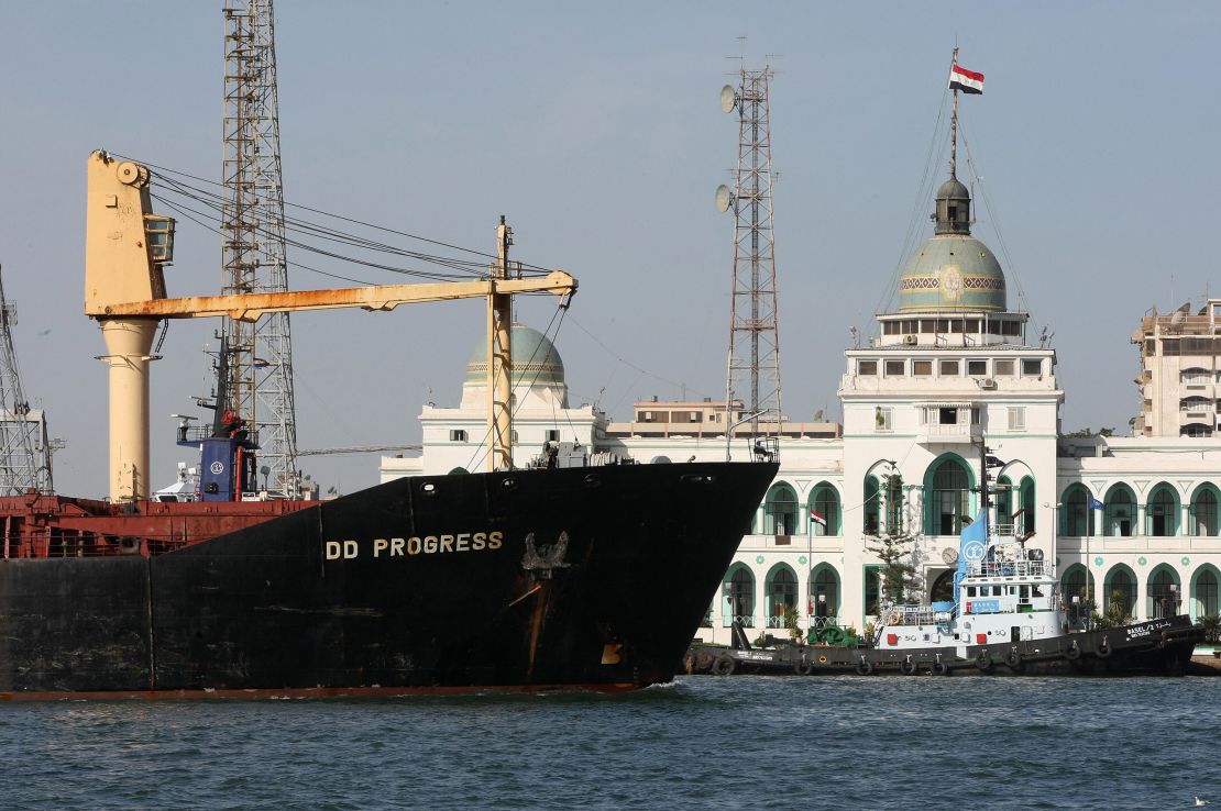 A cargo ship navigates in the Suez Canal, past the port authority building of Port Said, in 2008. The passageway hosts nearly 19,000 vessels each year.