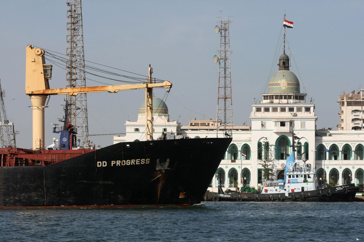 A cargo ship navigates past the Suez Canal Authority Building in Port Said, 180 kilometers northeast of Cairo, on November 24, 2008.