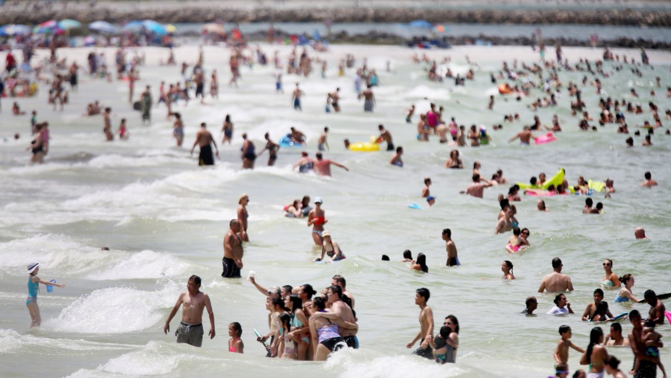 Beachgoers snap a photo together in Clearwater, Florida, on Thursday, July 23.