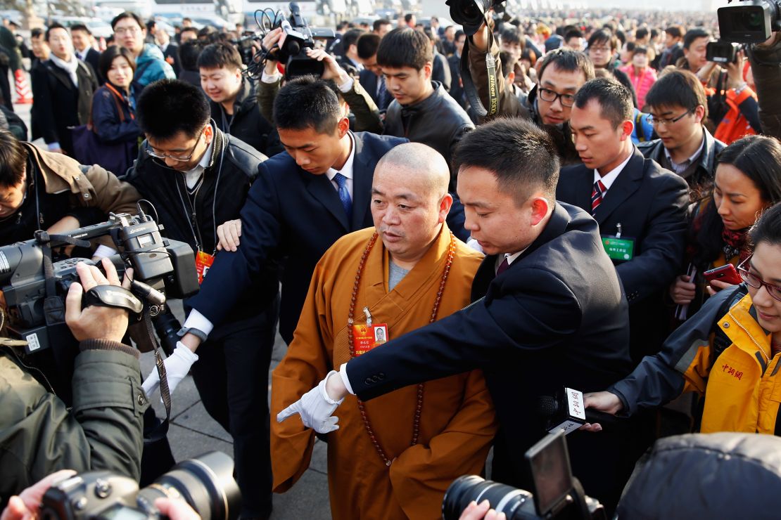 Shi Yongxin (C) Abbot of Shaolin Temple, arrives at The Great Hall Of The People to attend the opening session of the annual National People's Congress at Great Hall of the People on March 5, 2013 in Beijing.