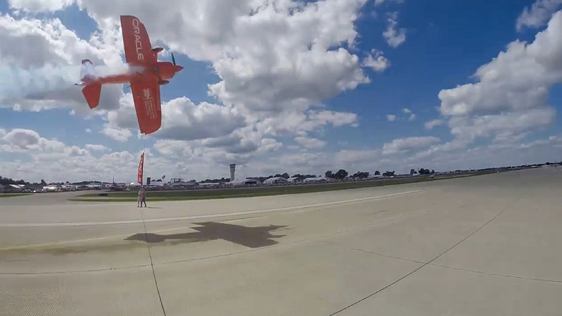 Tucker flies his plane sideways -- dangerously close to the ground -- during a performance last week.
