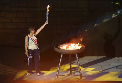 Nancy Glickman lights the flame at the European Maccabi Games in Berlin. She is the youngest daughter of Marty Glickman, one of two Jewish-American athletes denied the chance to run at the 1936 Olympics in the German capital, along with Sam Stoller.