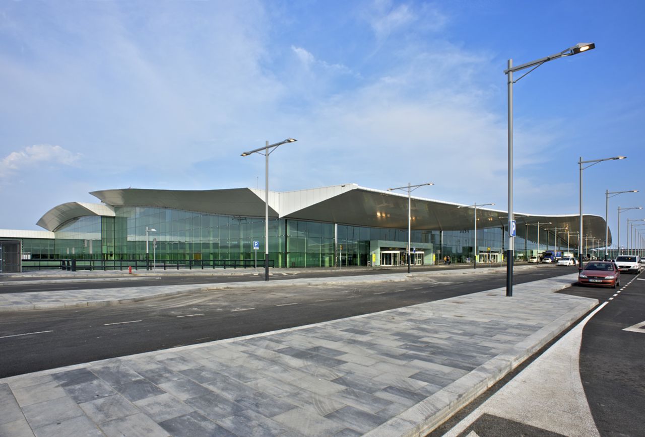 The new and improved eco-friendly terminal at Barcelona El Prat Airport opened in 2009, boasting floor-to-ceiling glass walls for natural light and an aluminum roof lined with solar panels to supply the building's energy. 