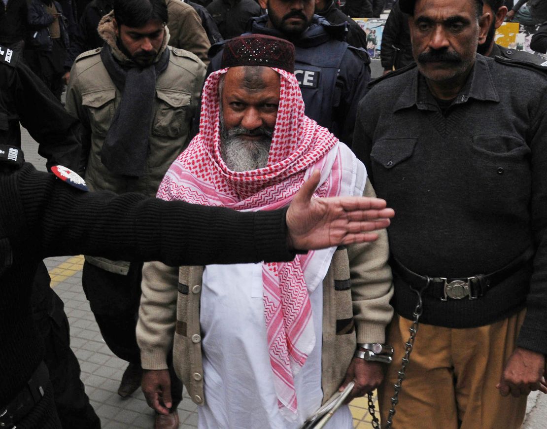 Police escort Lashkar-e-Jhangvi leader Malik Ishaq as he arrives at court in Lahore in 2014.