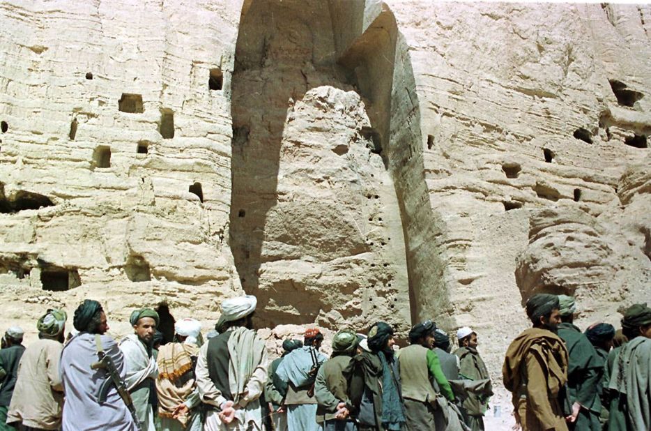 In March 2001, Taliban soldiers stand at the base of the mountain alcove where a Buddha statue once stood 170 feet high in Bamiyan, Afghanistan. The Taliban destroyed two 1,500-year-old Buddha figures in the town, saying they were idols that violated Islam.
