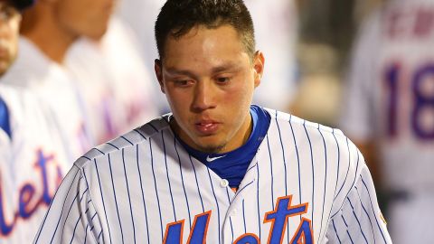 Mets shortstop Wilmer Flores looks on from the dugout during a game against the San Diego Padres.