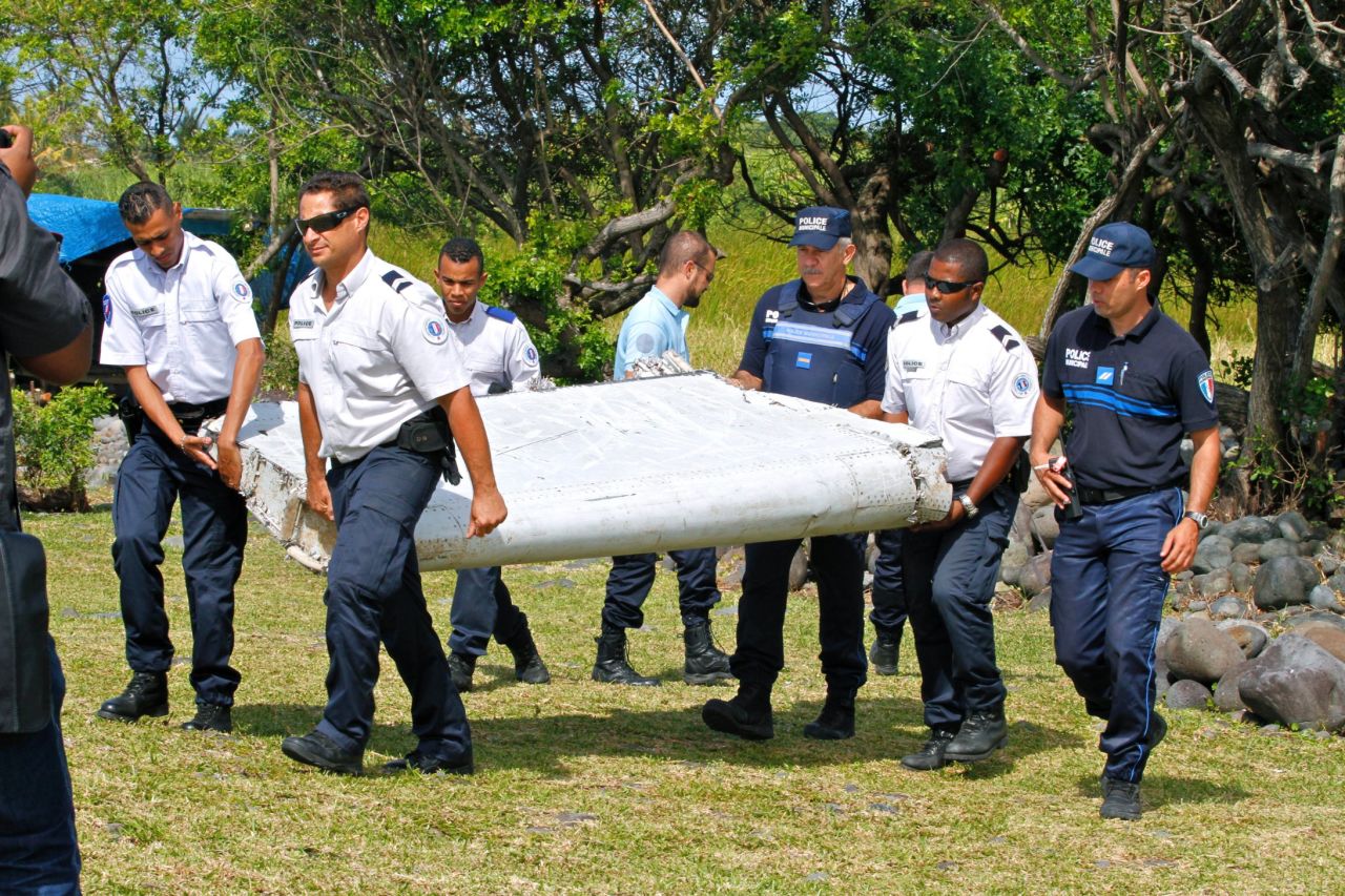 Police carry debris on July 29.