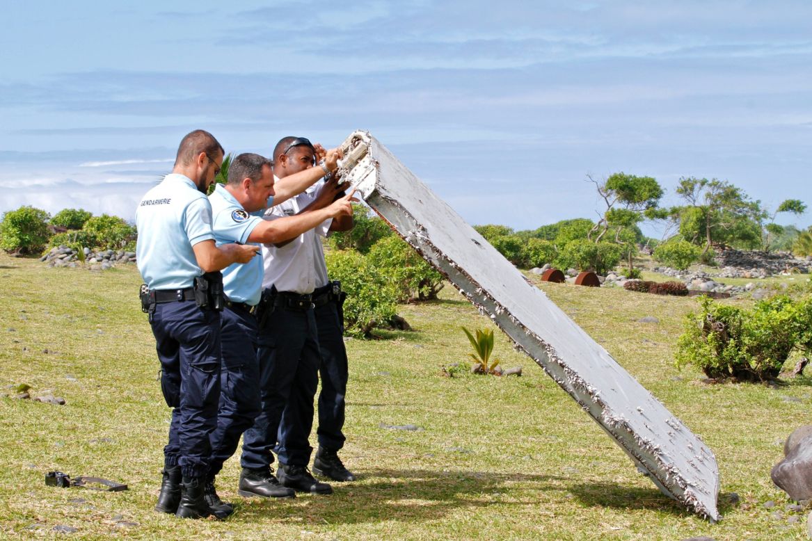 Police officers inspect debris on July 29.