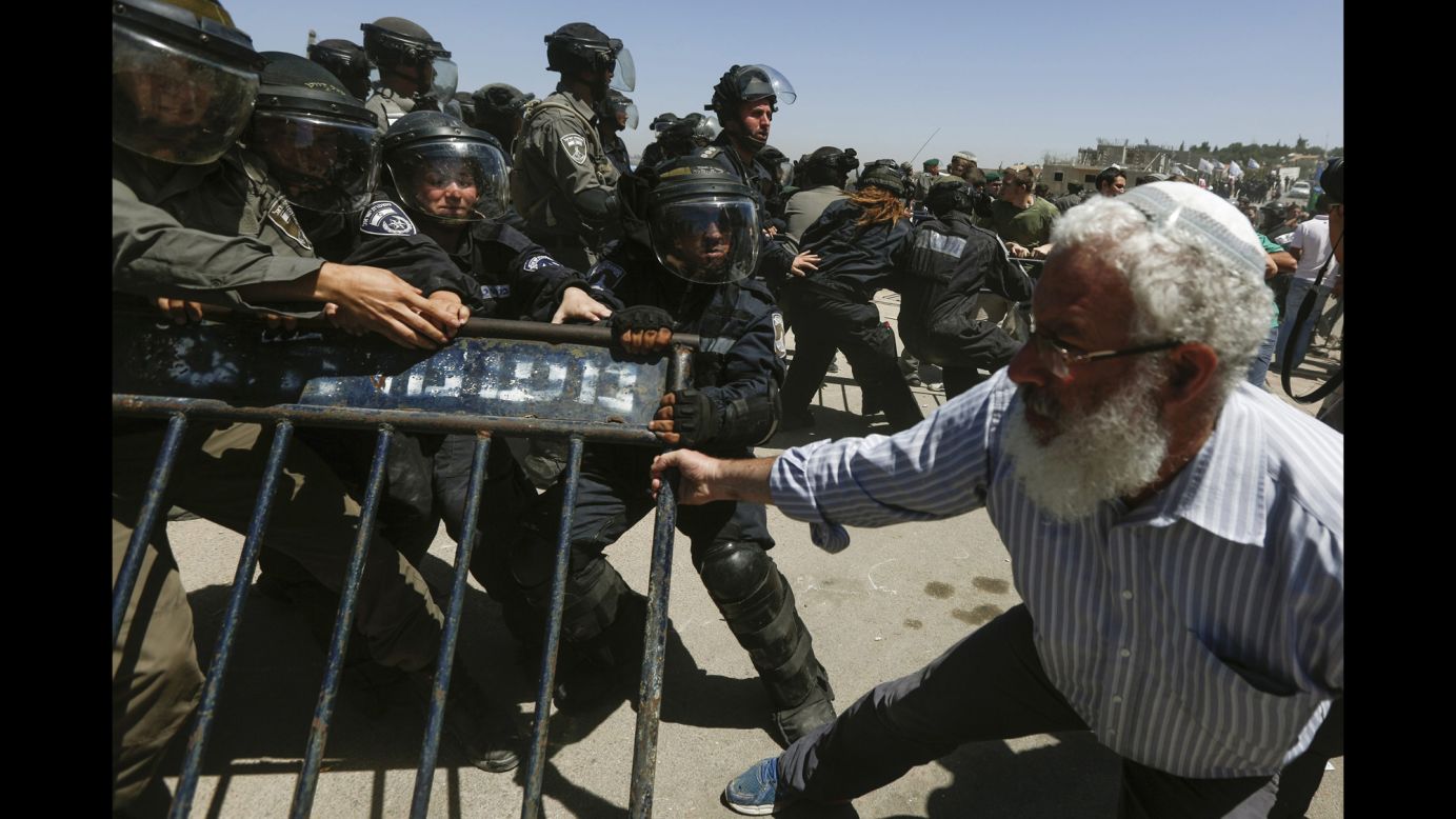 Israeli security forces scuffle with Israeli settlers from the West Bank settlement of Beit El during the demolishing of 24 housing units on Wednesday, July 29. Israel's Supreme Court ruled that the housing units had been built illegally and must be demolished.