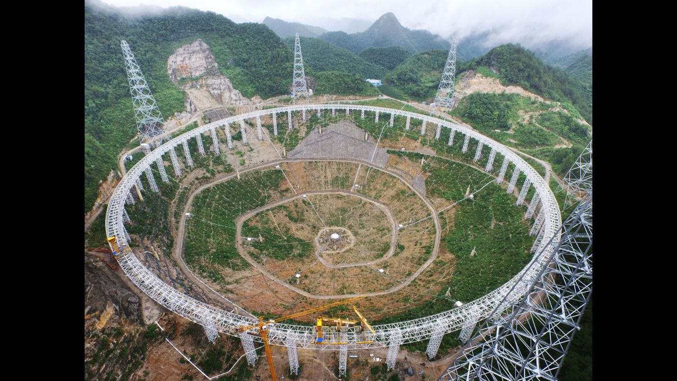 Construction continues on the Five-hundred-meter Aperture Spherical Telescope, also known as FAST, on Tuesday, July 28. FAST is being built in the mountains of China's Pingtang County, and when it's finished in September 2016 it will be used mainly for capturing radio signals in the universe. It will be the world's largest radio telescope. 