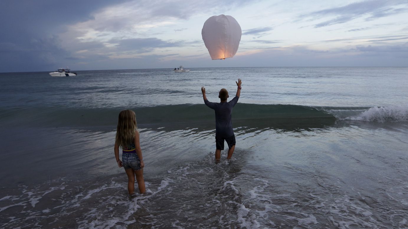 Andrew Grubowski, 10, releases a lantern in Stuart, Florida, during a vigil for Austin Stephanos and Perry Cohen on Tuesday, July 28. The two teenagers <a href="http://www.cnn.com/2015/07/28/us/florida-missing-teens-boat/" target="_blank">have been missing</a> since July 24, when they went out on a boat to go fishing. The boat was found capsized off the Florida coast on July 26.