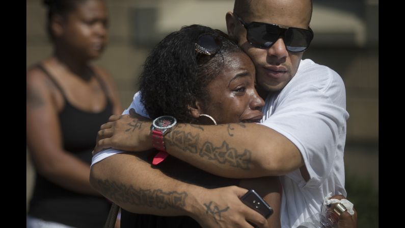 Shanicca Soloman cries in the arms of her friend Terrell Whitney outside funeral services for Samuel DuBose on Tuesday, July 28. Dubose, 43, <a href="http://www.cnn.com/2015/07/30/us/ohio-sam-dubose-tensing/" target="_blank">was fatally shot </a>July 19 by a University of Cincinnati police officer who stopped him for a missing license plate. The officer, Ray Tensing, was fired from his job. He has pleaded not guilty to charges of murder and voluntary manslaughter.