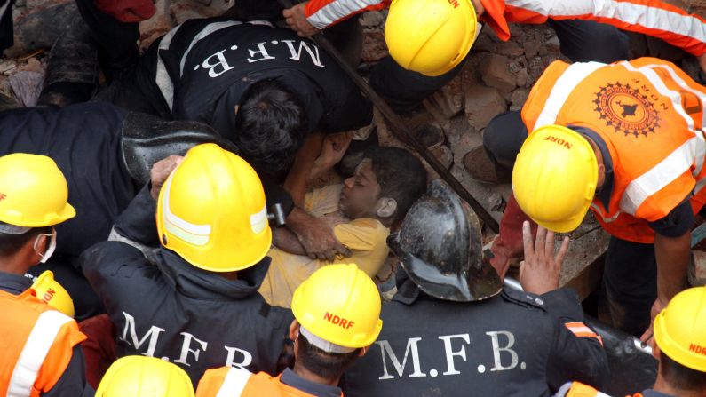 Rescuers carry the dead body of a victim who was killed when <a href="http://www.cnn.com/2015/07/29/asia/india-building-collapse/" target="_blank">a residential building collapsed</a> in Thane, India, on Tuesday, July 28. The three-story building collapsed during heavy rain.