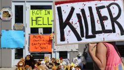 Protesters call attention to the alleged poaching of Cecil the lion, in the parking lot of Dr. Walter Palmer's River Bluff Dental Clinic on July 29, 2015 in Bloomington, Minnesota. According to reports, the 13-year-old lion was lured out of a national park in Zimbabwe and killed by Dr. Palmer, who had paid at least $50,000 for the hunt.