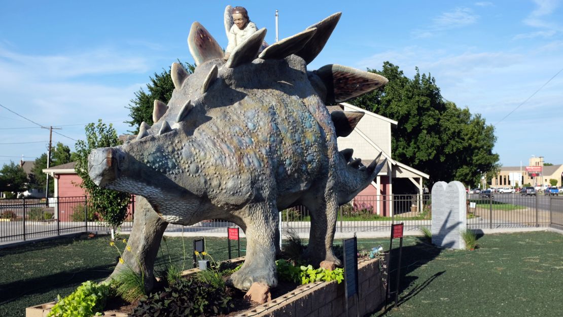 A sign in front of this statue reads, "A dinosaur like this roamed the Earth 5,000 years ago."