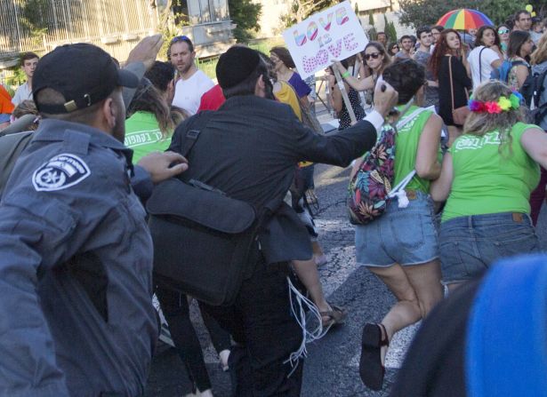 A man <a href="http://www.cnn.com/2015/07/30/middleeast/jerusalem-gay-pride-parade-stabbings/index.html" target="_blank">stabs a woman in the back</a> with a knife during a gay pride parade in Jerusalem on Thursday, July 30. Six people were stabbed, and two of those were injured seriously, Israeli police spokeswoman Luba Samri said. The suspect, Yishai Shlissel, was recently released from prison for committing a similar crime 10 years ago. 