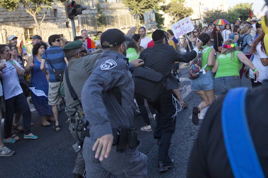 Security forces reach for a knife-wielding Schlissel.