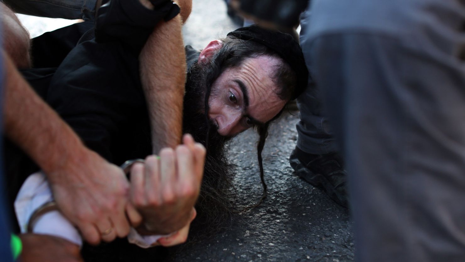 Yishai Shlissel in handcuffs in the aftermath of the knife attack in Jerusalem last July.