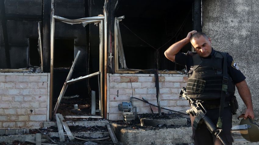 Caption:A member of the Israeli security forces inspects a Palestinian house that was set on fire by Jewish settlers in the West Bank village of Duma on July 31, 2015. A Palestinian toddler was burned to death and four family members injured in the arson attack on two homes in the occupied West Bank. AFP PHOTO / JAAFAR ASHTIYEH (Photo credit should read JAAFAR ASHTIYEH/AFP/Getty Images)