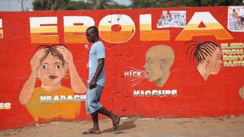 A man walks past an Ebola awareness painting in Monrovia on March 22, 2015.
