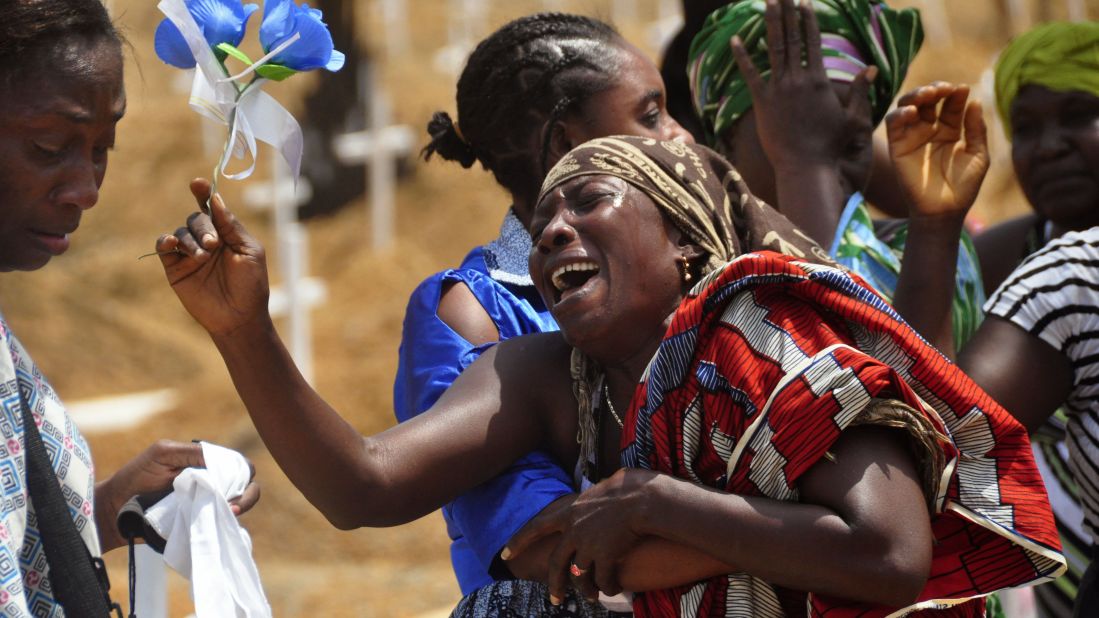 Relatives weep for a loved one who it was believed died from Ebola, at a graveyard on the outskirts of Monrovia on March 11, 2015.