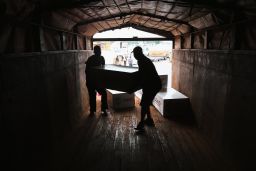 Workers unload medical supplies from a USAID cargo flight in Liberia in August.