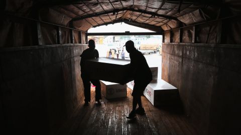 Workers unload medical supplies from a USAID cargo flight in Liberia in August.
