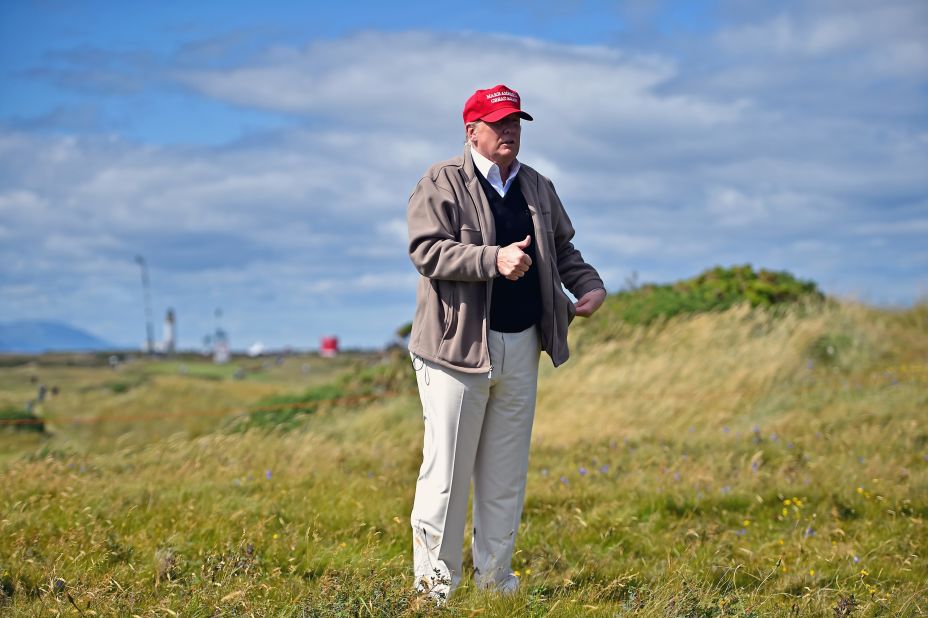 Trump walks his Turnberry golf course on July 30.