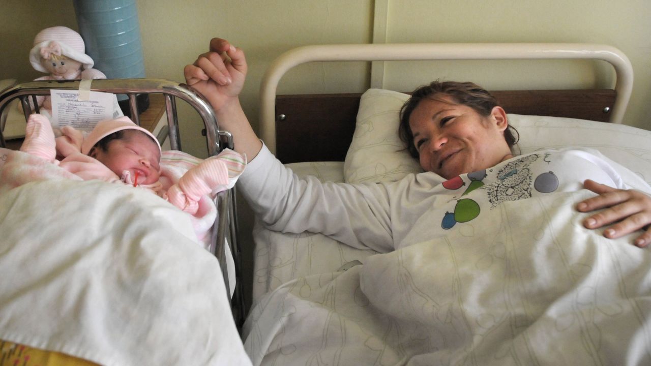 Margarita Segovia, the wife of miner Ariel Ticona, rests beside their newborn daughter Esperanza at a hospital in Copiapo on September 14.