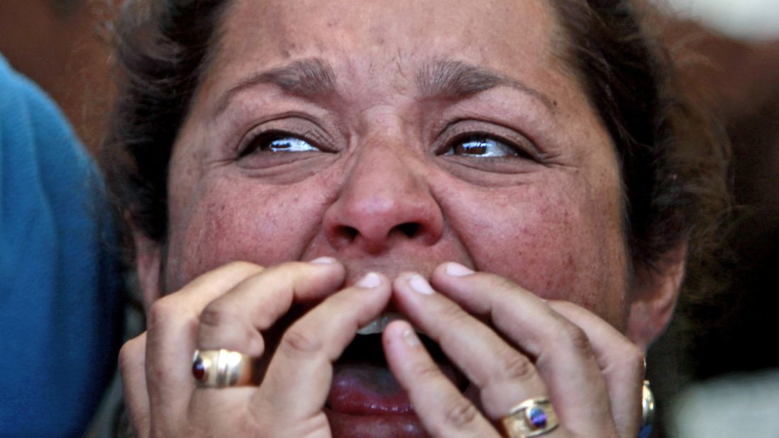 Loreto Campbell, a relative of miner Jorge Galleguillos, reacts while watching his rescue on a TV screen at the camp outside the mine on October 13. Galleguillos was the 11th of 33 miners who were rescued.