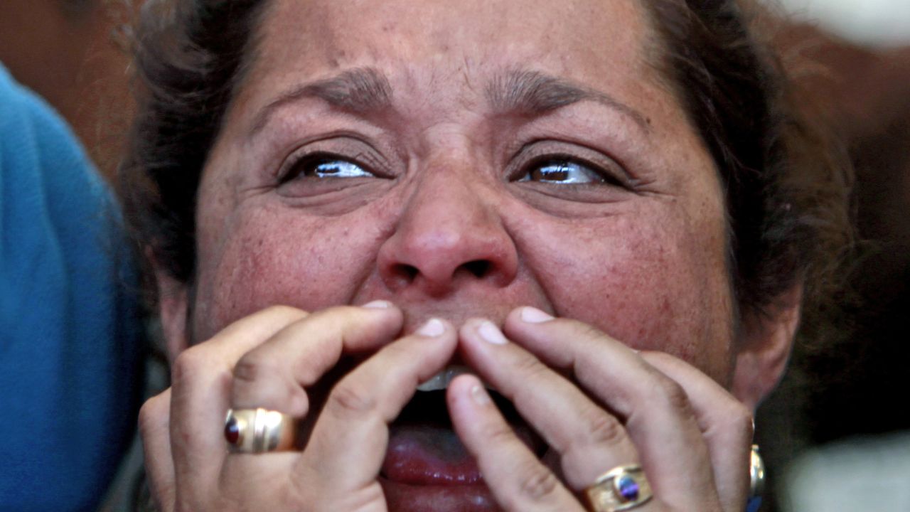 Loreto Campbell, a relative of miner Jorge Galleguillos, reacts while watching his rescue on a TV screen at the camp outside the mine on October 13. Galleguillos was the 11th of 33 miners who were rescued.