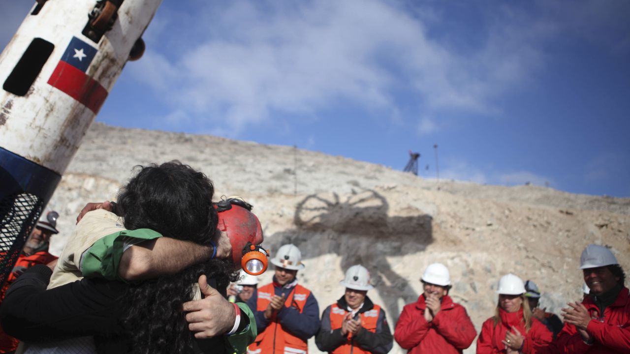 Miner Alex Vega hugs his wife after his rescue on October 13. All 33 miners were rescued.