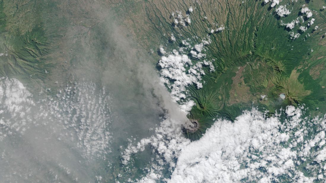 Ash and volcanic gases rise from the Mt. Raung volcano's caldera and drift northwest on the Indonesian island of Java. This image was captured by the Landsat 8 satellite on July 27. Mount Raung erupted at least 13 times in the past 25 years, according to the Smithsonian Global Volcanism program. The most recent eruption has been going for about four weeks. Ash has forced authorities to temporarily cancel flights and close airports. 