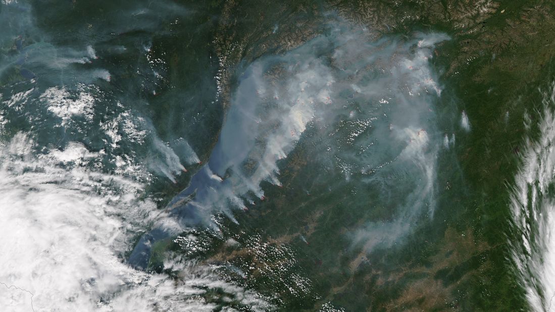 Smoke from fires near the shoreline of Russia's Lake Baikal was captured by NASA's Aqua satellite on July 27. The red spots show where fires were most active. Lake Baikal is the largest freshwater lake by volume in the world, but its water levels have dropped in recent months, according to the Reuters news agency.