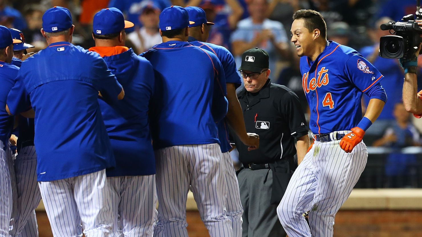 Wilmer Flores, right, of the New York Mets celebrates after hitting a home run in the 12th inning. 