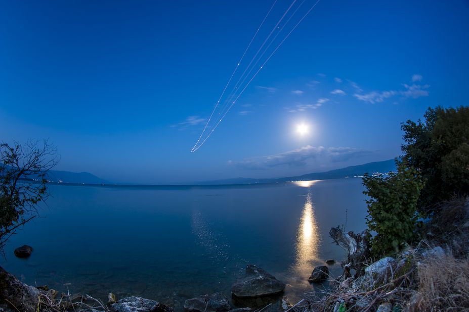 <a href="http://ireport.cnn.com/docs/DOC-1261121">Stojan Stojanovski</a> was near the Ohrid "St. Paul the Apostle" Airport to photograph the blue moon.  "The moon was very bright," he said. He waited for planes to take off from the airport to get this long exposure shot. 