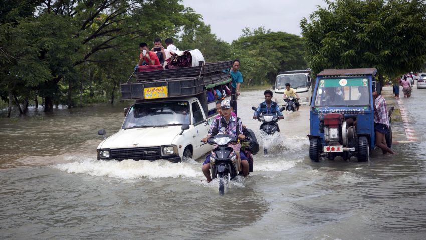 Vehicles make their way through a flooded road in Bago, 80 kilometers (50 miles) northeast of Yangon, Myanmar, Saturday, Aug 1.