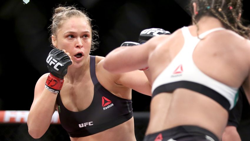 Caption:RIO DE JANEIRO, BRAZIL - AUGUST 01: Ronda Rousey of the United States (red) fights Bethe Correia of Brazi (blue) l in their bantamweight title fight during the UFC 190 Rousey v Correia at HSBC Arena on August 1, 2015 in Rio de Janeiro, Brazil. (Photo by Matthew Stockman/Getty Images)