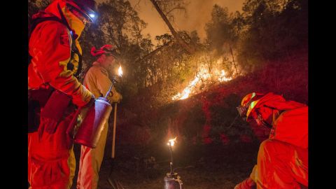 Firefighters light backfires in an attempt to control the blaze near Clearlake on August 2.