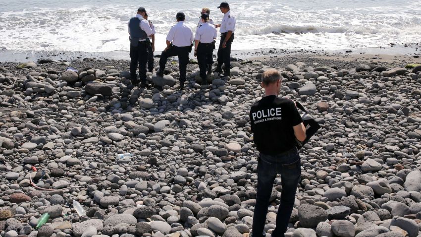 Police officers inspect metallic debris found on a beach in Saint-Denis on the French Reunion Island in the Indian Ocean on August 2, 2015, close to where where a Boeing 777 wing part believed to belong to missing flight MH370 washed up last week. A piece of metal was found on La Reunion island, where a Boeing 777 wing part believed to belong to missing flight MH370 washed up last week, said a source close to the investigation. Investigators on the Indian Ocean island took the debris into evidence as part of their probe into the fate of Malaysia Airlines flight MH370, however nothing indicated the piece of metal came from an airplane, the source said. AFP PHOTO / RICHARD BOUHETRICHARD BOUHET/AFP/Getty Images