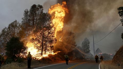 Firefighters spray a hose at a fire near Lower Lake on July 31.