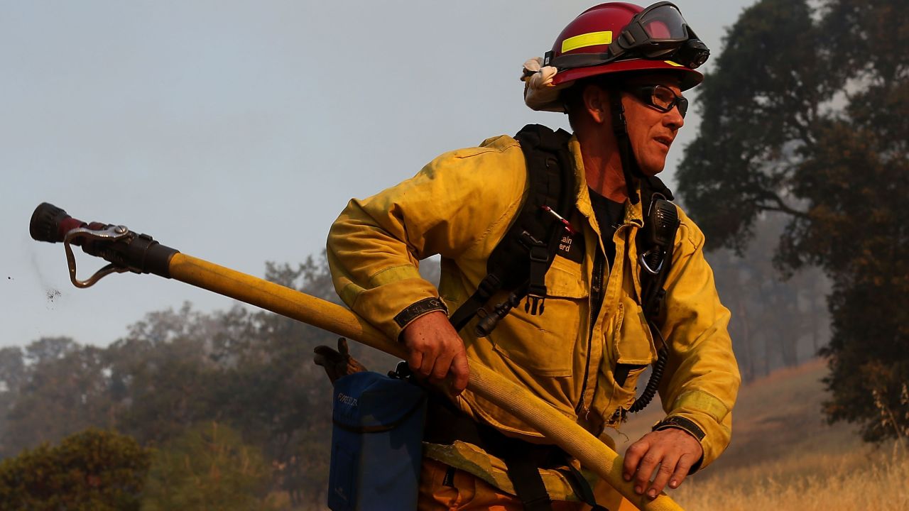 A firefighter prepares to douse spot fires in Lower Lake on July 31.