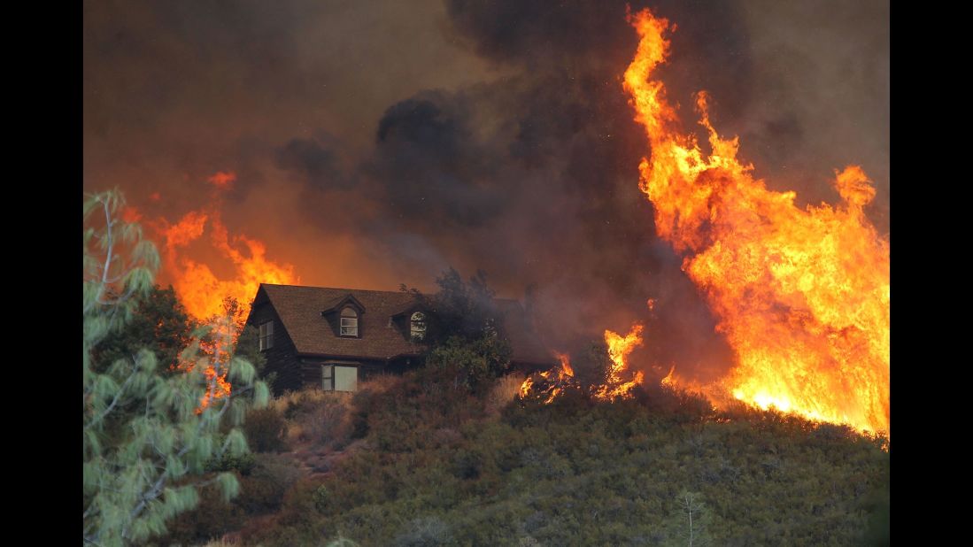 Flames approach a house in Lower Lake on Friday, July 31.