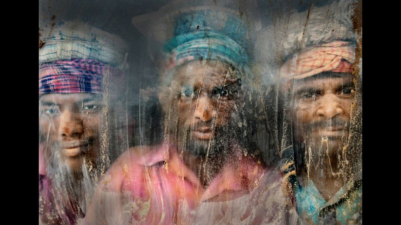 "(This) gravel-crush working place remains full of dust and sand," Azim said of this photo from Chittagong, Bangladesh. "Three gravel workmen are looking through the window glass at their working place."
