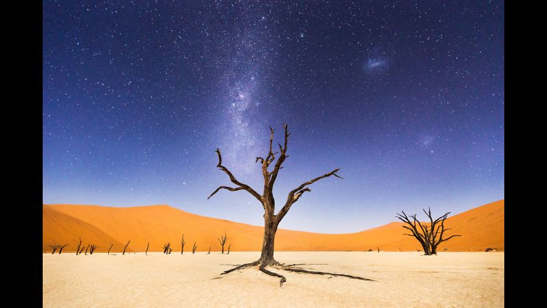 "The night before returning to Windhoek, we spent several hours at Deadvlei" in Namibia, McCarley said. "The moon was bright enough to illuminate the sand dunes in the distance, but the skies were still dark enough to clearly see the Milky Way and Magellanic Clouds. Deadvlei means 'dead marsh.' The camelthorn trees are believed to be about 900 years old but have not decomposed because the environment is so dry."