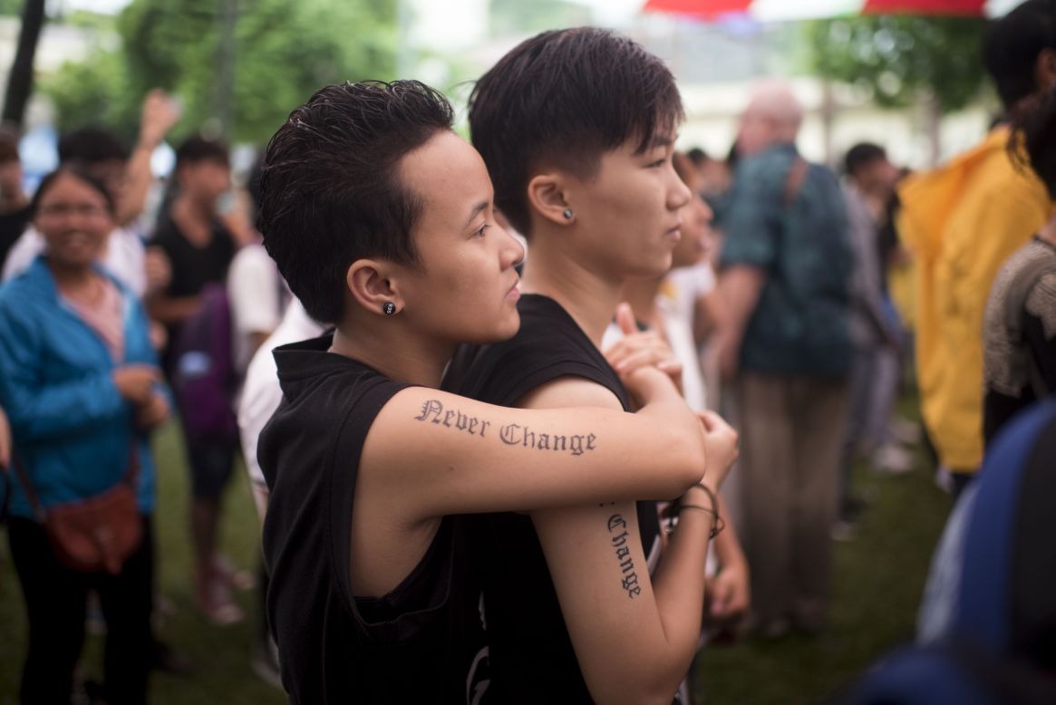 Two marchers enjoy live music during the fourth gay pride parade on August 2, 2015 in Hanoi, Vietnam. Hundreds of demonstrators marched through the streets of the Vietnamese capital to call for an end to discrimination against the country's lesbian, gay, bisexual and transgender (LGBT) community.