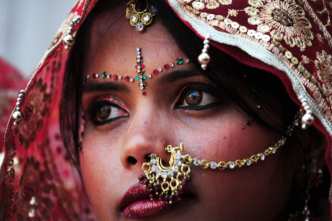 An Indian bride adorned in gold jewelry for her big day